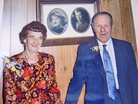 August William Kahn and wife Mary Ann Hotchkin, 50th Anniversary, wedding picture in background